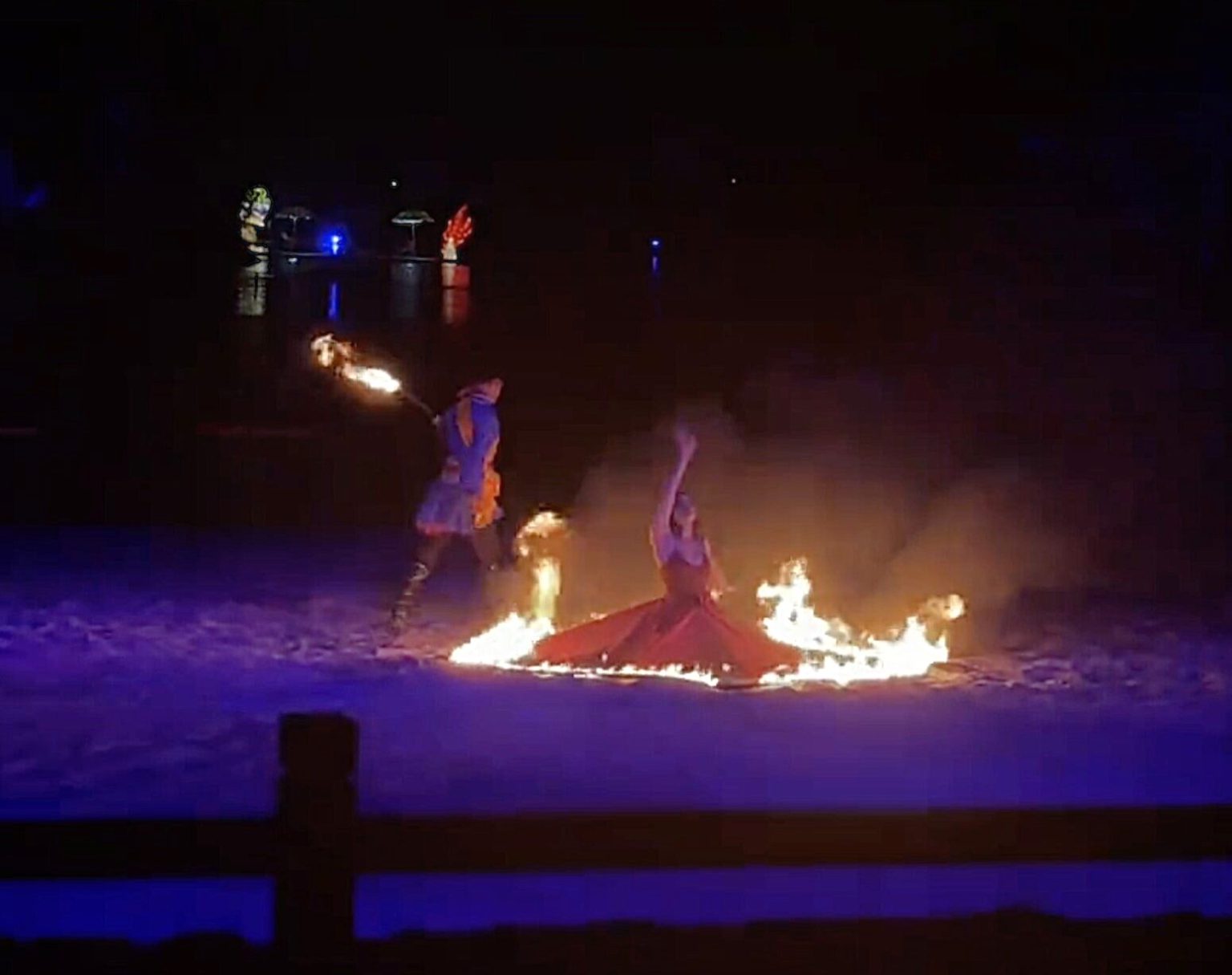 A dancer was engulfed in flames during a fire show at a zoo before leaping into a river to save herself, escaping serious injury in the dramatic incident.