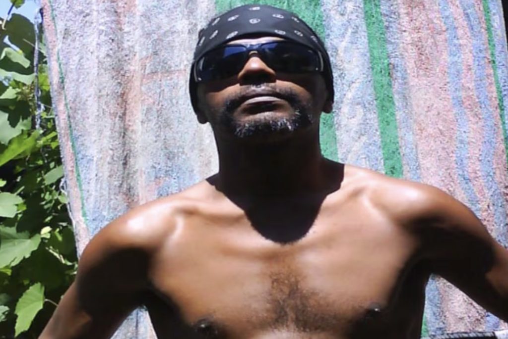 Two men have been arrested after a pioneering rapper was found buried in a septic tank at his home, with police investigating a suspected robbery turned deadly.