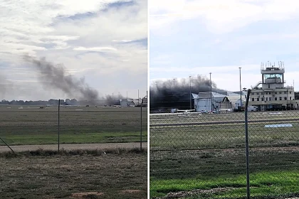 Two people died and more than a dozen were injured after a light aircraft nosedived into a hangar at Parafield Airport in Adelaide, sparking a massive blaze visible for miles.
