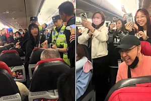 A passenger was thrown off an AirAsia flight after screaming that crew should speak Chinese instead of English, causing a nearly two-hour delay before police removed her.