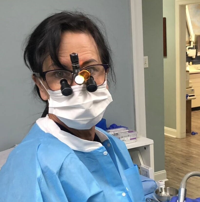 A former dentist was sentenced to life in prison for fatally shooting her boyfriend through a locked bedroom door during a jealous rage over him allegedly sending money to another woman.