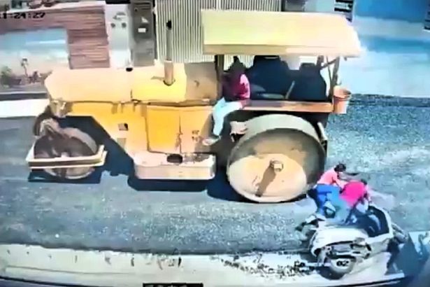 Father killed and his nine year old daughter left fighting for her life after their scooter slips and sends them straight into the path of a road roller.