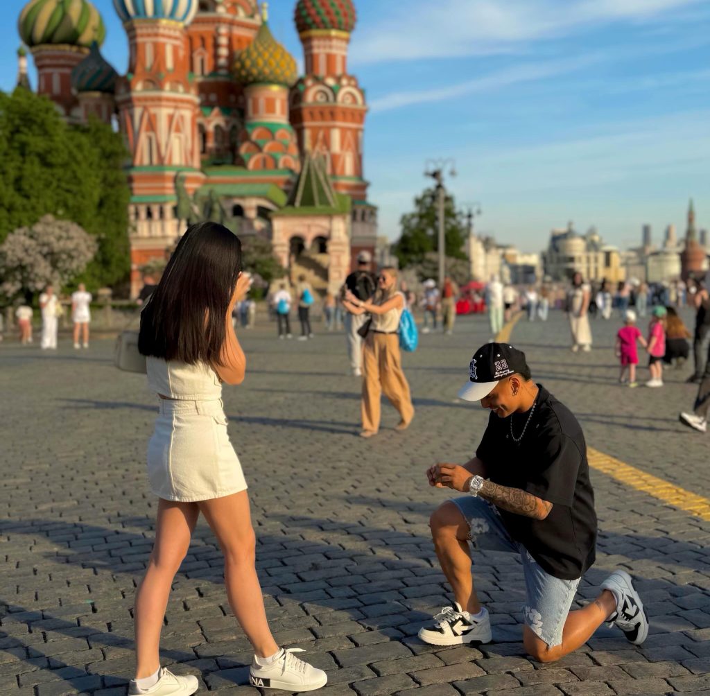Chilean footballer Jordhy Thompson announces engagement to girlfriend Camila Sepúlveda in Moscow's Red Square three years after being charged with her attempted murder.