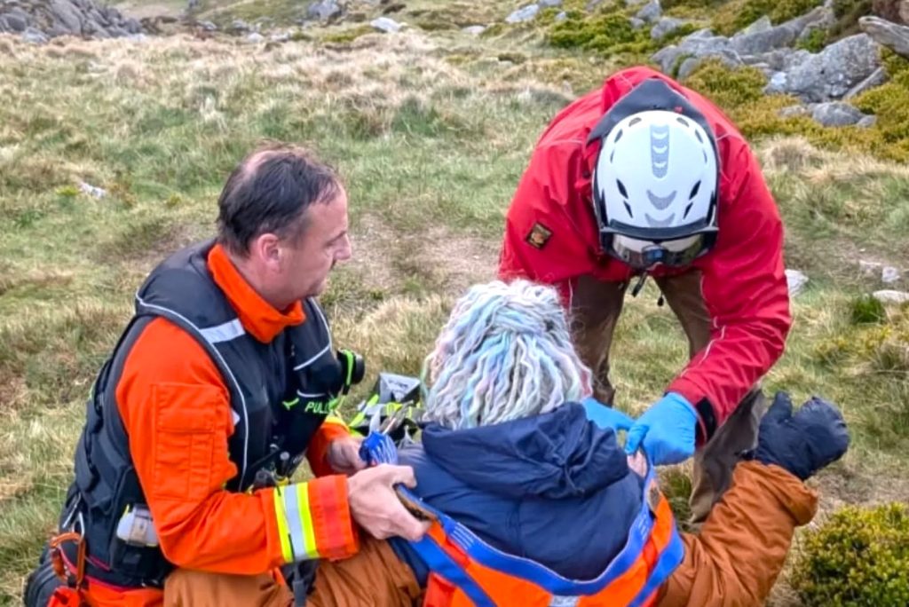 Hiker with ankle injury rescued by maritime coastguard helicopter after becoming stranded on Tryfan mountain in Wales, airlifted to safety by emergency crew.