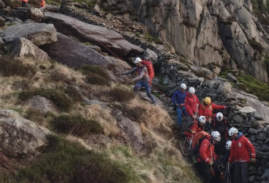Hiker with ankle injury rescued by maritime coastguard helicopter after becoming stranded on Tryfan mountain in Wales, airlifted to safety by emergency crew.