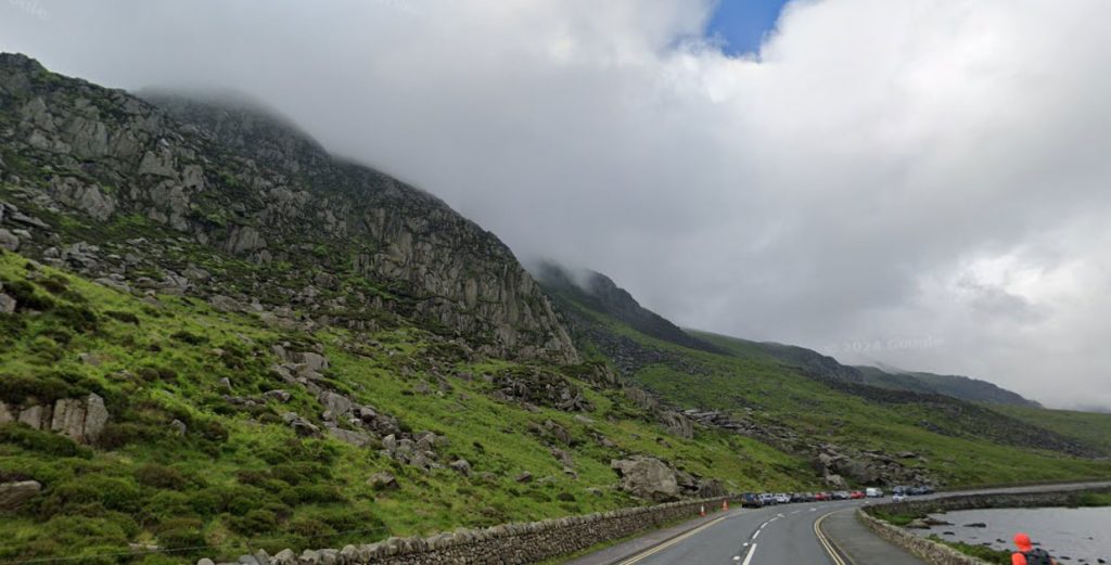 Hiker with ankle injury rescued by maritime coastguard helicopter after becoming stranded on Tryfan mountain in Wales, airlifted to safety by emergency crew.
