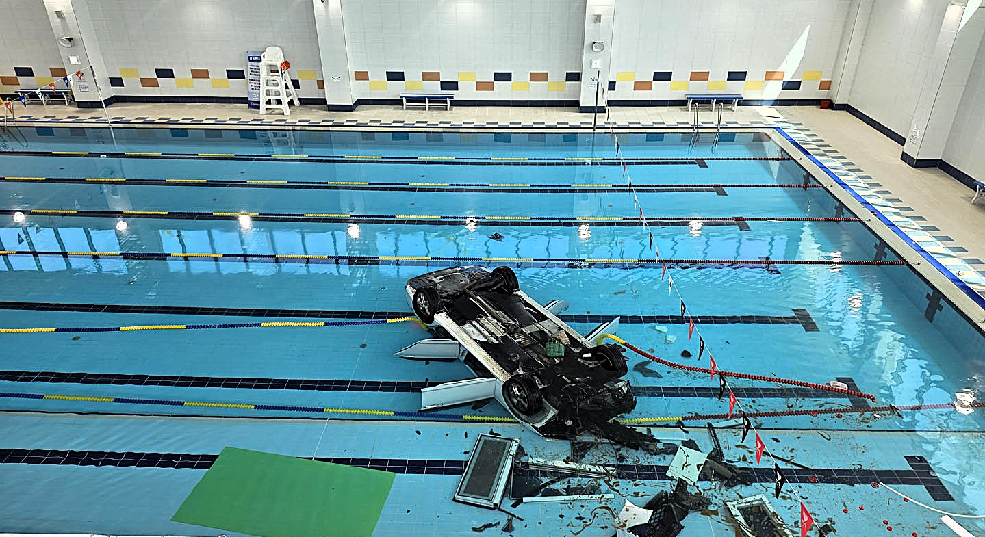 Elderly driver, 74, crashed her car through glass wall plunging 16ft into indoor swimming pool at Hanam Sports Centre, South Korea, rescued by swimmers.