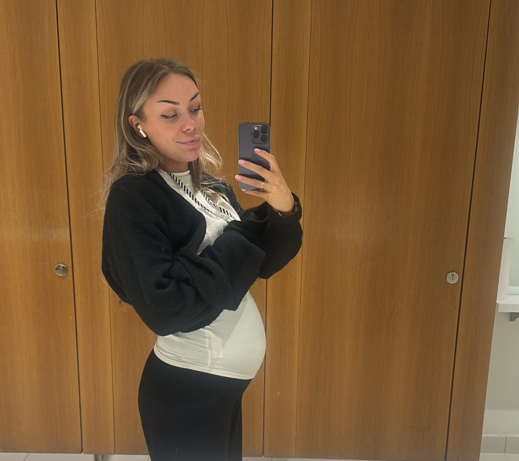 British influencer goes viral after hiding her huge six-week pregnancy bump at work - but trolls insist it's just bloat and she's hitting back.