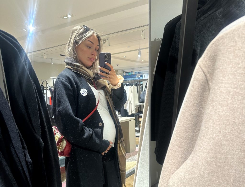 British influencer goes viral after hiding her huge six-week pregnancy bump at work - but trolls insist it's just bloat and she's hitting back.