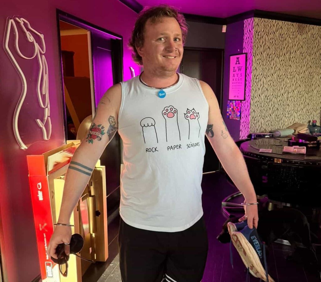 Bradley "serves" his glam influencer girlfriend - but travelling together has led to some awkward moments, including being stopped at airport security over his outfit.