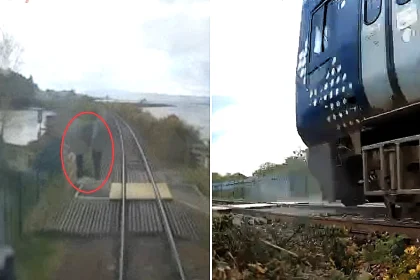 Reckless youngsters caught playing chicken on railway tracks as trains thundered past, forcing terrified driver to slam on emergency brakes in shocking near-miss footage.