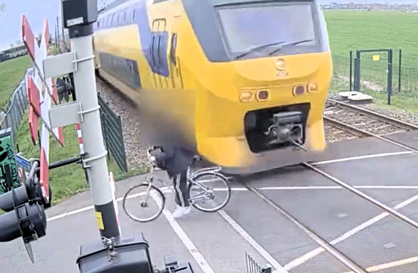 A Dutch teen cyclist missed death by inches when a speeding train narrowly avoided him at a level crossing, with rail firm ProRail releasing the footage as part of a teen safety campaign.