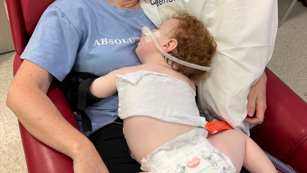 Toddler who nearly died after inhaling cake decorating dust during his birthday cake nightmare is finally awake, smiling and breathing on his own again.