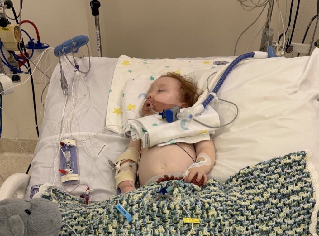 Toddler who nearly died after inhaling cake decorating dust during his birthday cake nightmare is finally awake, smiling and breathing on his own again.