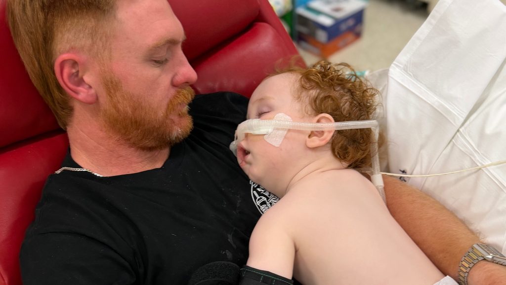 Toddler who nearly died after inhaling cake decorating dust during his birthday cake nightmare is finally awake, smiling and breathing on his own again.