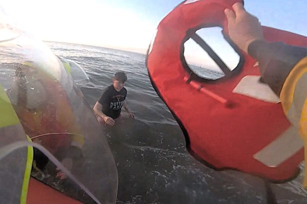 Dramatic footage shows a person trapped in quicksand at Rhyl beach being rescued by lifeboat crews just as the incoming tide rose to their waist.