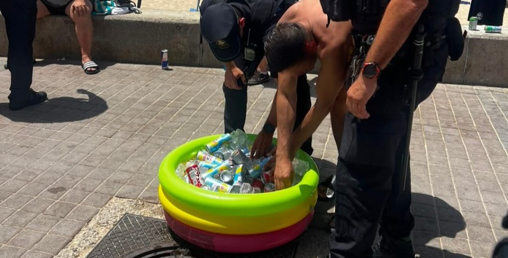 Police shut down an illegal beach party in Mallorca and confiscated 100 bottles of alcohol after a group of 20 Brits set up a tent, paddling pool full of booze and a blasting speaker.