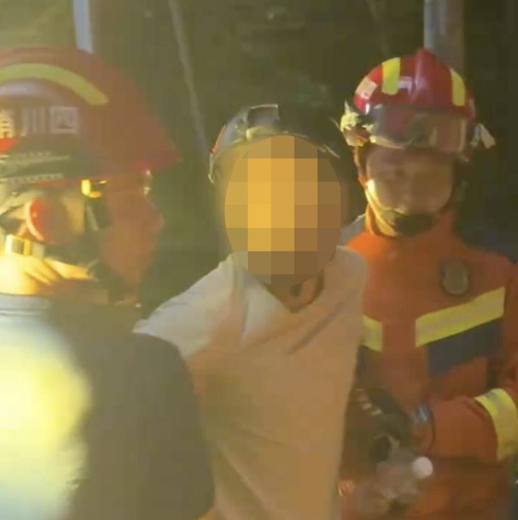 A paraglider was left dangling from a 197ft construction crane after his lines became tangled in the structure - firefighters spent hours cutting him free in a night-time rescue operation.
