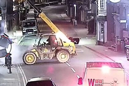 A gang used a stolen telehandler to rip a cash machine clean out of a Nationwide branch wall in a 3am ram raid, making off with tens of thousands of pounds in minutes.