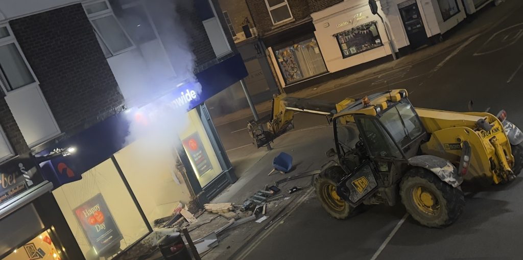 A gang used a stolen telehandler to rip a cash machine clean out of a Nationwide branch wall in a 3am ram raid, making off with tens of thousands of pounds in minutes.