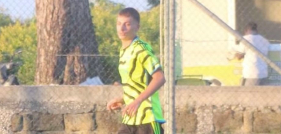A 21-year-old footballer was shot dead outside his home in Naples after a grudge over a five-a-side foul festered for months - the suspect is a 16-year-old with clan ties.