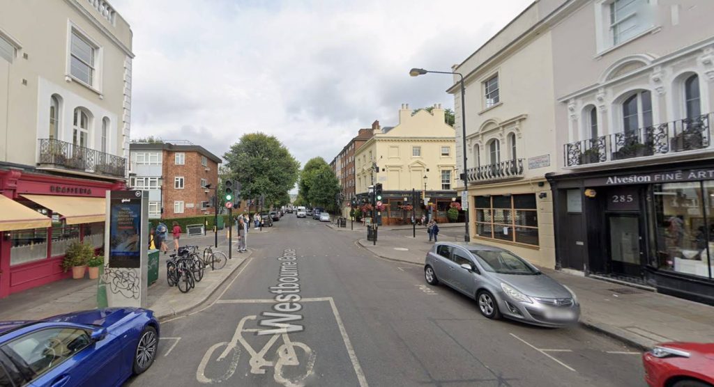 A woman on Portobello Road repeatedly called a masked man a "criminal" and told him to "get a job" as he sawed through a bike lock - and he left without taking the bicycle.