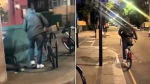 A woman on Portobello Road repeatedly called a masked man a "criminal" and told him to "get a job" as he sawed through a bike lock - and he left without taking the bicycle.