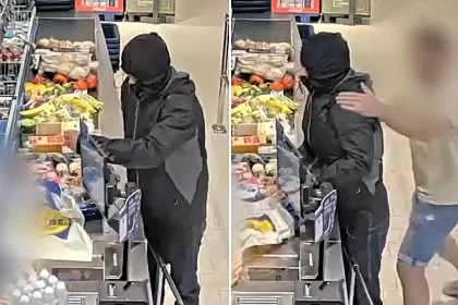 A have-a-go hero grabbed an "armed" robber by the neck and shoved him into a barrier at a Lidl in the Netherlands - the suspect fled empty-handed as the customer chased him out.