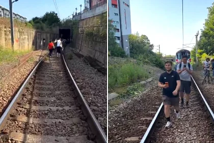 Two hundred passengers were forced to walk along railway tracks outside the Emirates Stadium after a train broke down in 34C heat, leaving them stranded for three hours.