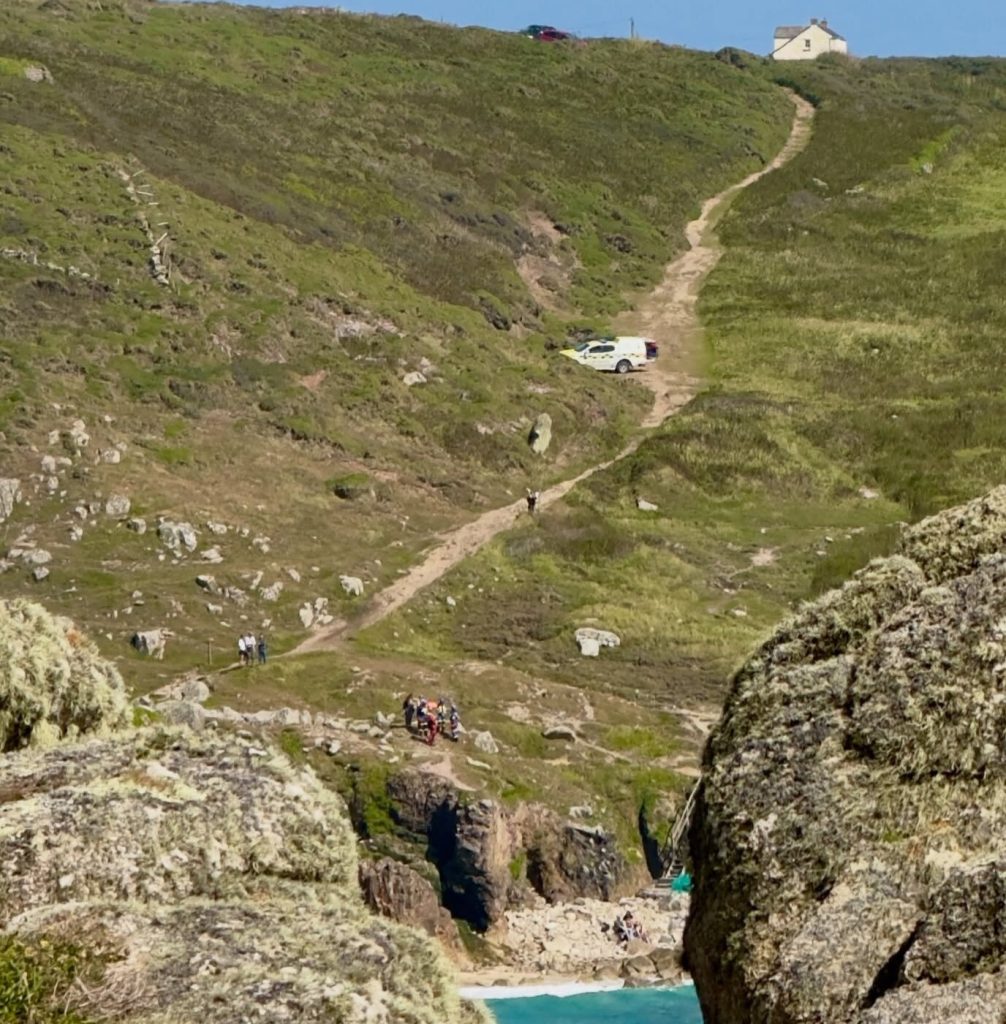 Rescuers rushed to a woman stranded on a tiny rock surrounded by sea in Cornwall after locals spotted her sitting in a chair - crews had to wait hours for the tide to drop to reach her.