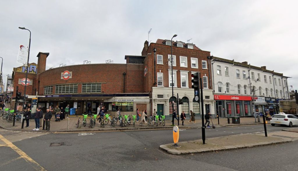 A street brawl erupted outside Wood Green Tube station as temperatures hit 30C - with three men wielding camping chairs to chase and attack another man before bystanders stepped in.