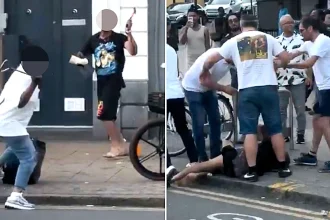 A street brawl erupted outside Wood Green Tube station as temperatures hit 30C - with three men wielding camping chairs to chase and attack another man before bystanders stepped in.