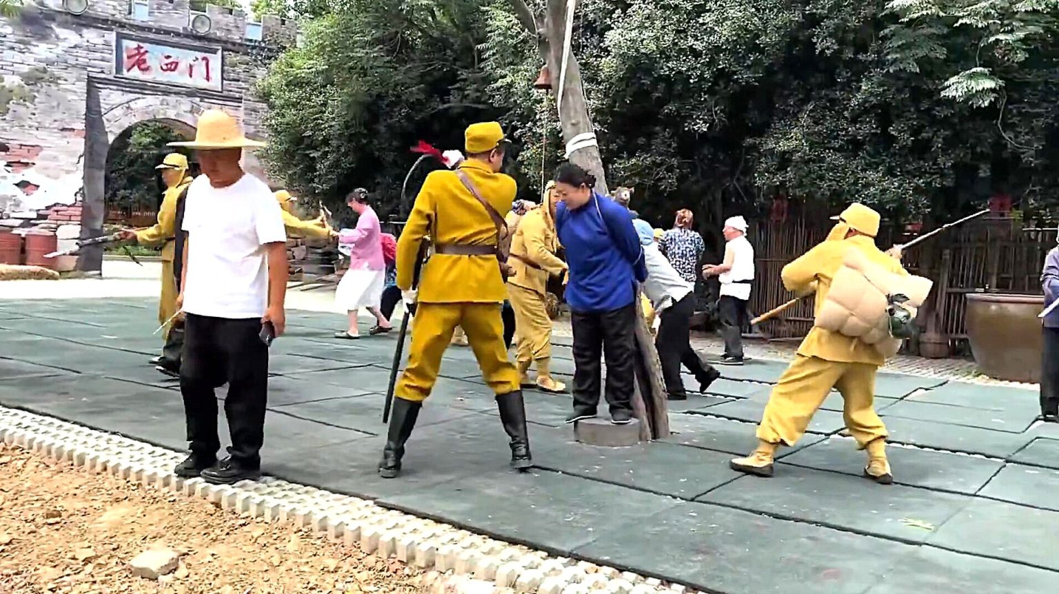 A tourist flew into a rage and drop-kicked an actor during a war reenactment in China, throwing punches before staff dragged him back into the audience as spectators watched in disbelief.