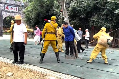 A tourist flew into a rage and drop-kicked an actor during a war reenactment in China, throwing punches before staff dragged him back into the audience as spectators watched in disbelief.