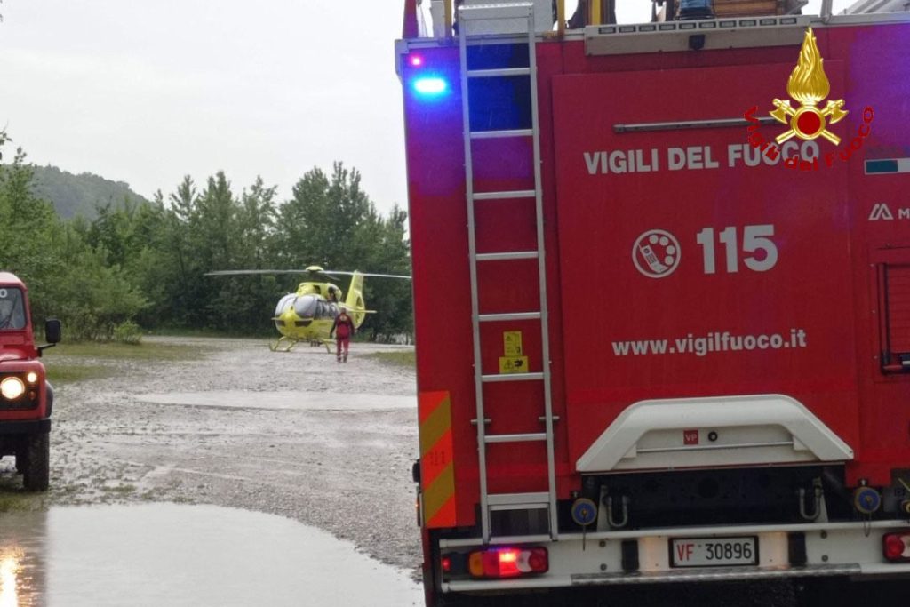 Two tourists and their dogs had to be rescued by helicopter and river teams after driving their pickup truck into a fast-flowing Italian river - and getting stranded in the middle.