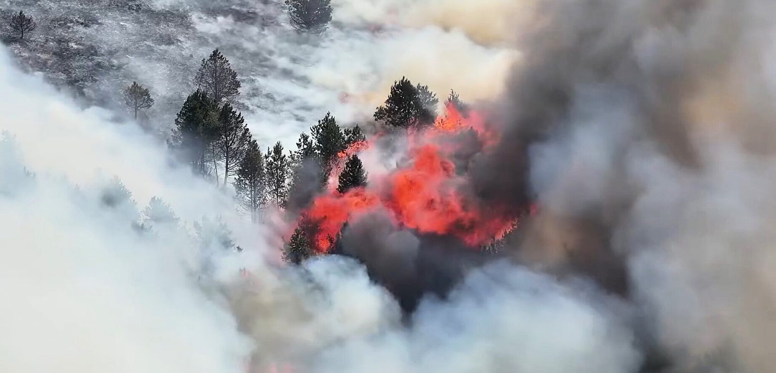 Britain's record-breaking June heatwave sparked a huge wildfire on Derbyshire moorland, sending a massive plume of smoke billowing for miles as crews and a helicopter battled the blaze.