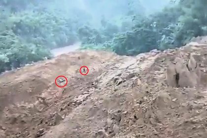A biker cheated death by leaping from his bike seconds before a massive landslide swept down a mountainside and engulfed the road in Arunachal Pradesh, India.
