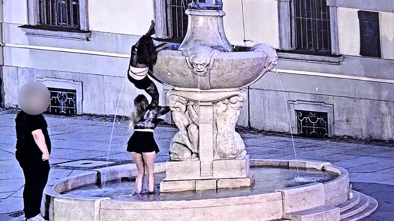 Two boozed-up women caught on CCTV stealing a sword from a historic naked fencer statue in Poland, with one collared by cops and now facing charges.