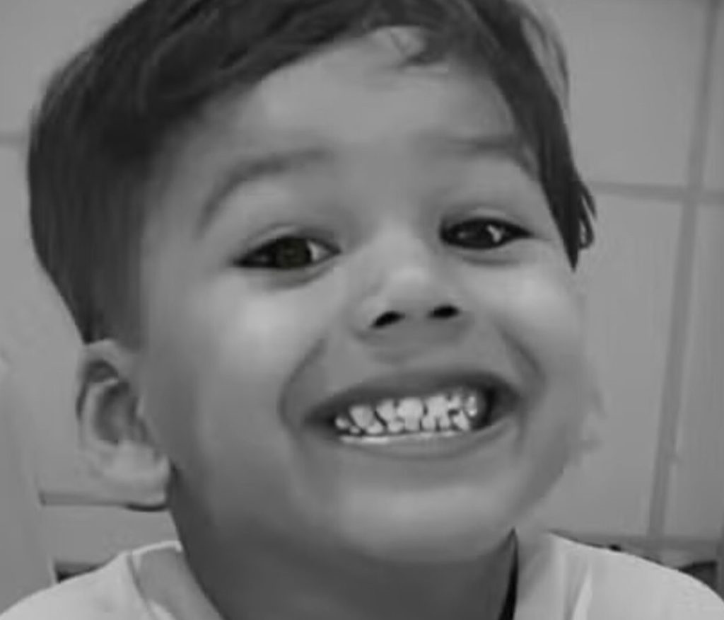 A five-year-old boy has died after being electrocuted by the metal frame of a beach stall in Brazil - his mum was shocked too as she tried to pull him free.
