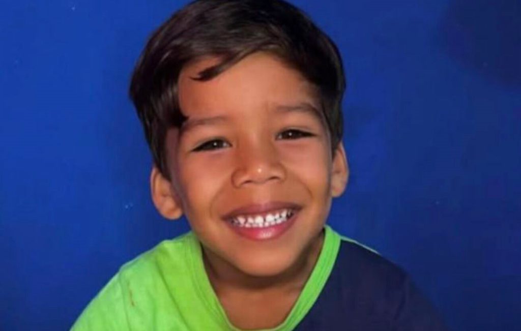 A five-year-old boy has died after being electrocuted by the metal frame of a beach stall in Brazil - his mum was shocked too as she tried to pull him free.
