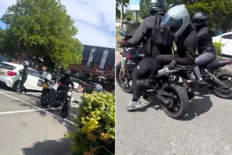 A bumbling bike gang were filmed botching a motorbike theft in broad daylight - fleeing empty-handed after failing to remove the cover and even flipping off a witness.