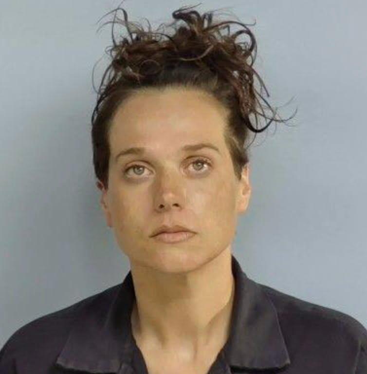 Woman accused of murder is on the run after the remains of a missing man are found in a shallow grave, with police warning she may have changed her appearance.