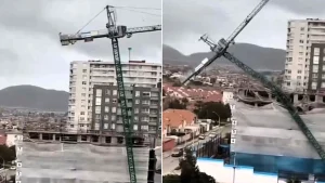 A giant crane was blown over by powerful winds and crashed onto a row of homes in Chile, damaging six houses - a 13-year-old girl inside had a lucky escape.