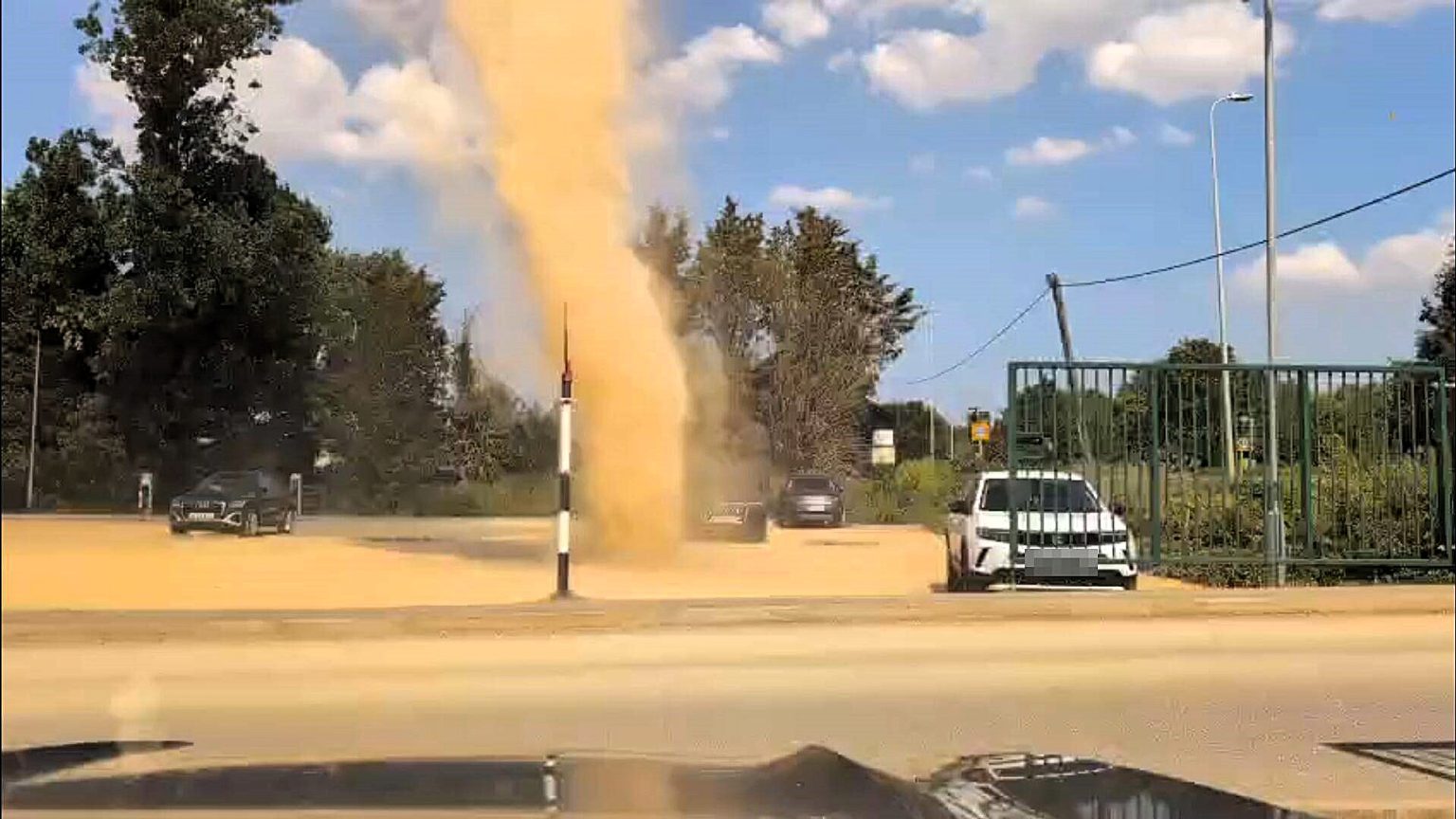 A "mini tornado" sends dust swirling high over a farm shop car park in Lincolnshire as Britain's scorching summer continues - staff say it's not something they see every day.