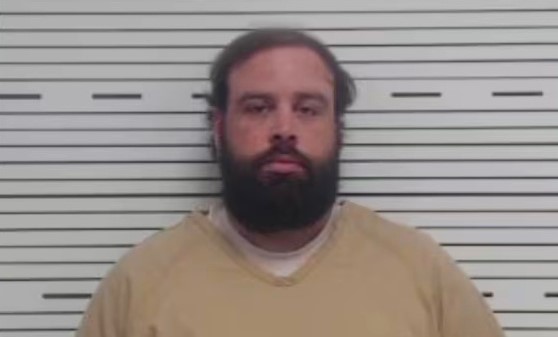 A driver accused of killing a mother and three of her children by running a red light has handed himself in almost three months on, after being indicted in Alabama.