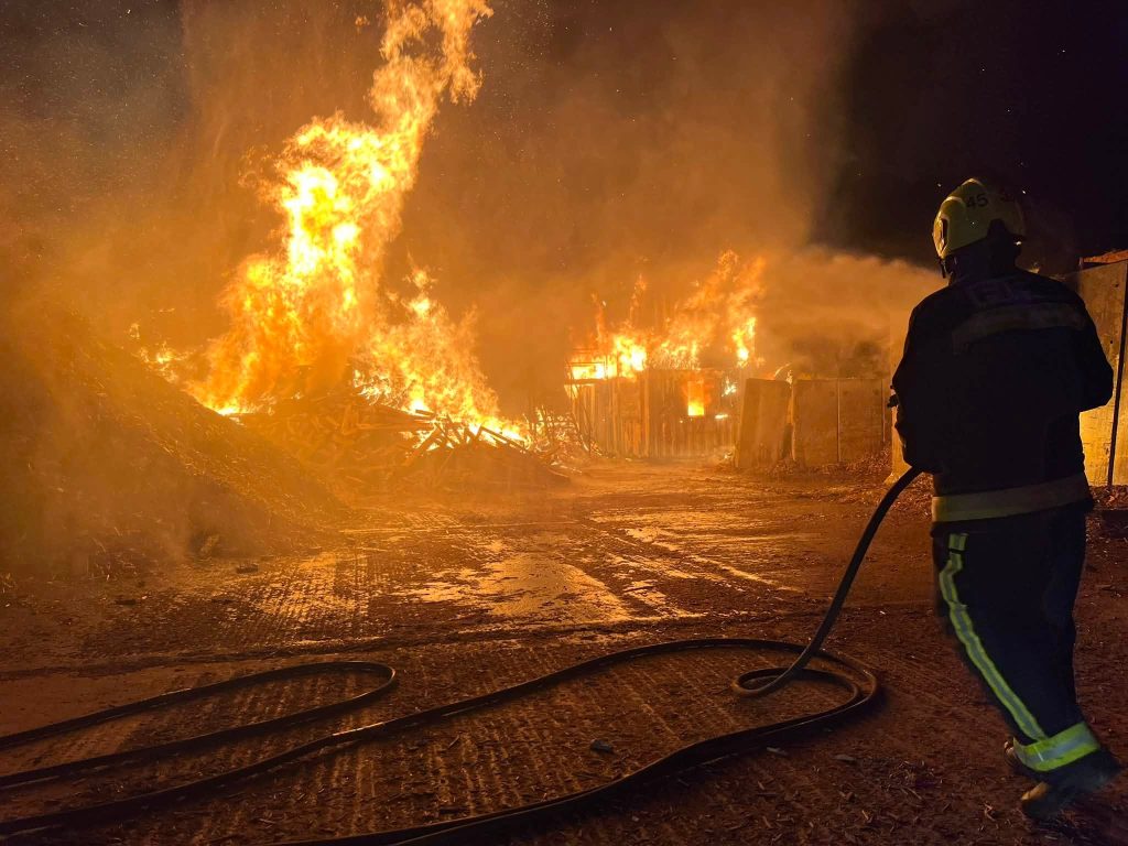Firefighters from five stations battled a raging inferno as 200 tons of wood erupted into flames near Taunton during Britain's scorching summer heatwave.