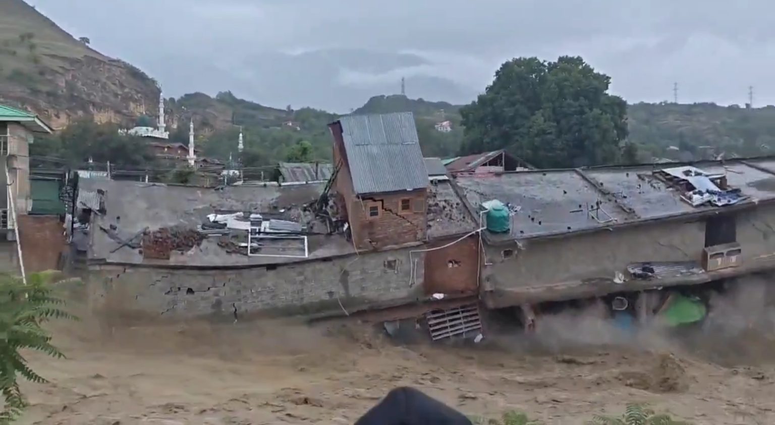 Dozens of shops were swept away after the Sukhnag river burst through a shopping complex in Kashmir - but advance warnings meant everyone escaped unharmed.