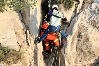 Tourist Ren Mou survives 180ft cliff plunge in China after getting wedged in a crevice, sparking a five-hour overnight rescue mission to save her.
