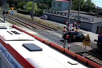 Two teens seriously injured after their car is struck by a freight train at a level crossing in Poland after ignoring flashing red warning signals.