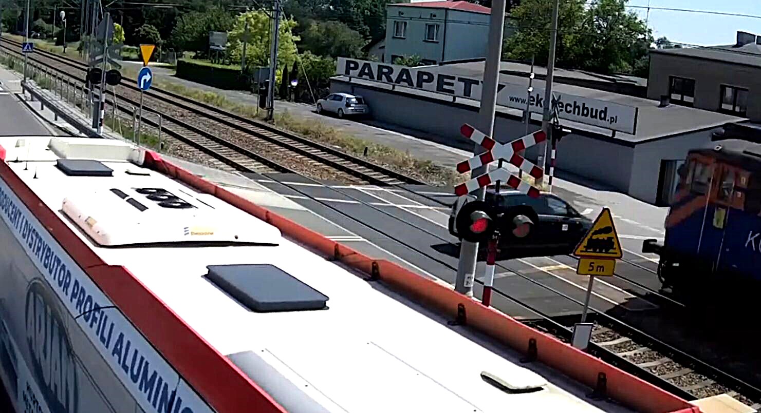 Two teens seriously injured after their car is struck by a freight train at a level crossing in Poland after ignoring flashing red warning signals.